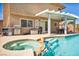 Covered patio with outdoor dining area, BBQ, and poolside spa for ultimate outdoor living at 266 Cordero Dr, Henderson, NV 89074