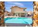 Spacious backyard featuring a pool, spa, covered patio, and ample space for entertaining at 266 Cordero Dr, Henderson, NV 89074