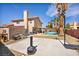 Spacious backyard featuring a refreshing pool, sports court, palm trees, and barbecue area at 266 Cordero Dr, Henderson, NV 89074