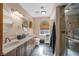 Bathroom featuring a double vanity, mirrors, tile floors, and arched windows at 266 Cordero Dr, Henderson, NV 89074