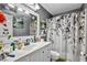 Bathroom with a white vanity, decorative mirror, and a shower with patterned curtain at 266 Cordero Dr, Henderson, NV 89074