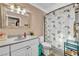 Cozy bathroom featuring granite vanity, a toilet, and a shower with mermaid-themed curtain at 266 Cordero Dr, Henderson, NV 89074