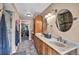 Bathroom featuring a double vanity, mirrors, tile floors, and arched windows at 266 Cordero Dr, Henderson, NV 89074