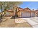 Charming home featuring a terracotta roof, a two-car garage, and desert-friendly landscaping at 266 Cordero Dr, Henderson, NV 89074