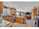 Traditional kitchen with wooden cabinets, granite countertops, stainless steel appliances adjacent to the living room at 266 Cordero Dr, Henderson, NV 89074