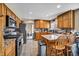 Traditional kitchen with wooden cabinets, granite countertops, stainless steel appliances and breakfast bar at 266 Cordero Dr, Henderson, NV 89074