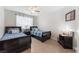 Charming bedroom with twin beds, wood-look floors, and a ceiling fan to provide a relaxing retreat at 2803 Marathon Dr, Henderson, NV 89074