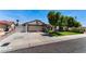 Home exterior featuring mature trees and long driveway leading to the two car garage at 2803 Marathon Dr, Henderson, NV 89074