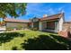 Beautiful home exterior featuring green grass, mature trees and desert landscaping at 2803 Marathon Dr, Henderson, NV 89074