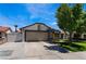 Home exterior featuring mature trees and long driveway leading to the two car garage at 2803 Marathon Dr, Henderson, NV 89074