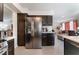 Bright kitchen featuring stainless steel appliances, sleek countertops, and dark wood cabinetry at 2803 Marathon Dr, Henderson, NV 89074