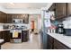 Charming kitchen with stainless steel appliances, dark wood cabinetry, and bright countertops at 2803 Marathon Dr, Henderson, NV 89074