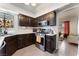 Modern kitchen with stainless steel appliances, dark wood cabinets, and stylish tiled flooring at 2803 Marathon Dr, Henderson, NV 89074