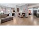 Open concept living space with a stone fireplace, wood floors, and access to a kitchen at 2803 Marathon Dr, Henderson, NV 89074