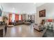 Open concept living room featuring laminate floors, a sectional couch and an oversized chair at 2803 Marathon Dr, Henderson, NV 89074