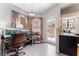 Bright office featuring multiple monitors, stylish curtains, and an entrance to the kitchen area at 2803 Marathon Dr, Henderson, NV 89074