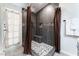 Modern shower featuring gray tile, mosaic accents, a built-in bench, and a rainfall shower head at 2803 Marathon Dr, Henderson, NV 89074