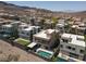 Expansive aerial view shows a neighborhood nestled into the mountain with community pools at 292 Crimson Edge St, Henderson, NV 89012