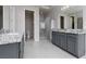 Bright bathroom with double vanities, granite countertops, modern fixtures, and a glass-enclosed shower at 292 Crimson Edge St, Henderson, NV 89012
