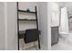 Stylish, modern bathroom features sleek black shelving, a gray vanity, and a tub with decorative tiling at 292 Crimson Edge St, Henderson, NV 89012