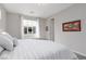 Comfortable bedroom featuring a large window and neutral decor with white linens at 292 Crimson Edge St, Henderson, NV 89012