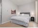 Comfortable bedroom featuring neutral walls, carpet, and a gray upholstered headboard at 292 Crimson Edge St, Henderson, NV 89012