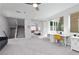 Bright bonus room with carpeting, ceiling fan, and staircase presents an inviting multi-use space at 292 Crimson Edge St, Henderson, NV 89012