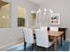 Elegant dining area boasts a stylish chandelier and large windows offering ample natural light at 292 Crimson Edge St, Henderson, NV 89012