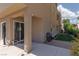 Exterior home featuring a covered patio, a grill, grass, and landscaping on a sunny day at 292 Crimson Edge St, Henderson, NV 89012