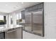 Modern kitchen features a stainless steel refrigerator, granite countertops, and backyard views at 292 Crimson Edge St, Henderson, NV 89012