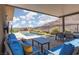 This covered patio offers mountain views and comfortable seating by the pool at 292 Crimson Edge St, Henderson, NV 89012