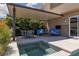 Backyard patio with covered seating area, outdoor furniture, and a spa for relaxing and entertaining at 292 Crimson Edge St, Henderson, NV 89012