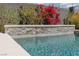 Close-up of a sparkling backyard pool with mosaic tile accents and vibrant bougainvillea landscaping at 292 Crimson Edge St, Henderson, NV 89012