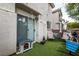 Cozy backyard features a small pet house and seating area on artificial turf at 3018 Sunrise Bay Ave, North Las Vegas, NV 89031