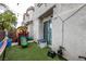 Fully fenced backyard with artificial turf, play structure and a sliding glass door at 3018 Sunrise Bay Ave, North Las Vegas, NV 89031