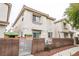 Two-story townhome featuring a private fenced yard with play equipment and outdoor lighting at 3018 Sunrise Bay Ave, North Las Vegas, NV 89031