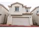 Inviting two-story home with a neutral stucco exterior and attached two-car garage at 3018 Sunrise Bay Ave, North Las Vegas, NV 89031