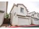 Well-maintained townhome features a red-tiled roof and an attached two-car garage at 3018 Sunrise Bay Ave, North Las Vegas, NV 89031