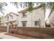 Exterior view of a townhome with a private fenced backyard featuring outdoor lighting at 3018 Sunrise Bay Ave, North Las Vegas, NV 89031