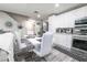 Bright living space adjacent to a modern kitchen, dining area, and open floor plan, great for entertaining at 3018 Sunrise Bay Ave, North Las Vegas, NV 89031