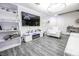 Inviting living room with a large TV, ambient LED lighting, and stylish white shelving for decor and storage at 3018 Sunrise Bay Ave, North Las Vegas, NV 89031