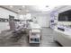 Bright living room area showcases modern white furniture, sleek hardwood-style floors, and integrated lighting at 3018 Sunrise Bay Ave, North Las Vegas, NV 89031
