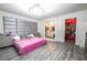 Stylish bedroom featuring a plush upholstered headboard, modern light fixture, and a view of the ensuite bathroom and walk-in closet at 3018 Sunrise Bay Ave, North Las Vegas, NV 89031