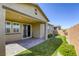 Landscaped backyard with a covered patio, putting green, and privacy wall at 3122 Berceto Ct, Henderson, NV 89044