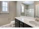 Well-lit bathroom with white countertops and ample storage in dark cabinets below the sink at 3122 Berceto Ct, Henderson, NV 89044