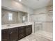 Bathroom featuring double sinks, a large mirror, and a glass-enclosed shower at 3122 Berceto Ct, Henderson, NV 89044