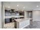 An elegant kitchen includes granite countertops, stainless steel appliances, and ample lighting at 3122 Berceto Ct, Henderson, NV 89044