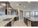 Spacious kitchen featuring a center island with a sink, stainless steel appliances, and an open layout to the adjacent living area at 3122 Berceto Ct, Henderson, NV 89044