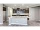 A modern kitchen features dark wood cabinetry, a granite island, and tile flooring at 3122 Berceto Ct, Henderson, NV 89044