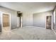 Spacious main bedroom with neutral carpet and multiple doorways leading to the bathroom and walk-in closet at 3122 Berceto Ct, Henderson, NV 89044